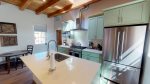 Kitchen island with stainless steel sink and top-of-the-line fixtures
